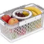 Clear plastic pantry storage container with fruits and handle.
