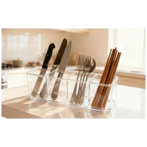 Transparent plastic cutlery organizer with knives, forks, and chopsticks.