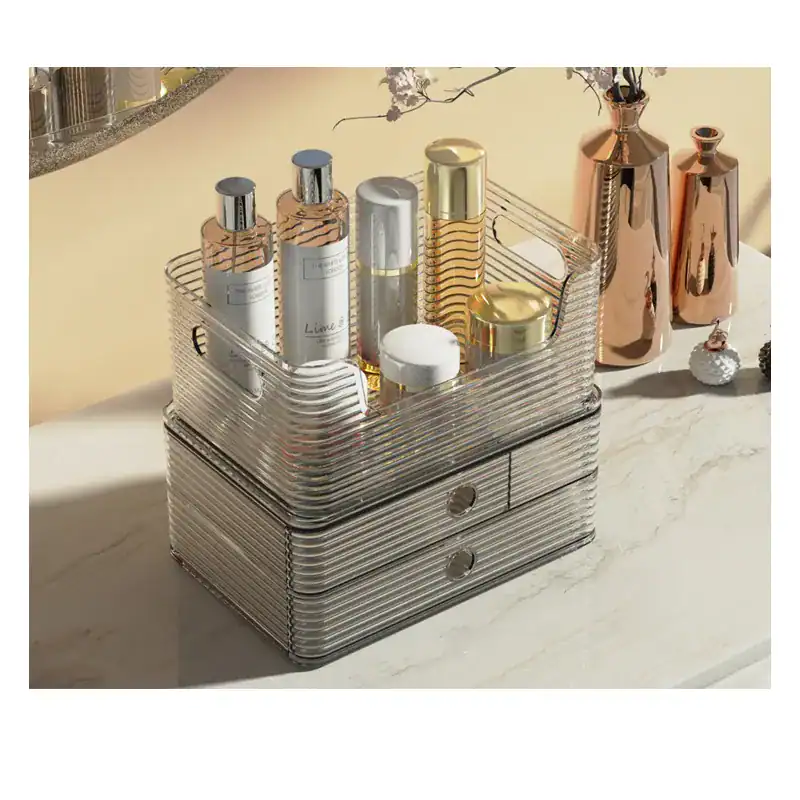 Elegant metal storage box with cosmetic bottles and vases on marble surface.