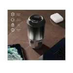 Insulated travel mug with leak-proof lid on desk with phone and laptop.