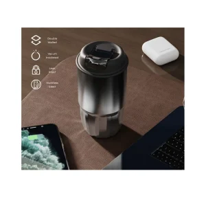 Insulated travel mug with leak-proof lid on desk with phone and laptop.
