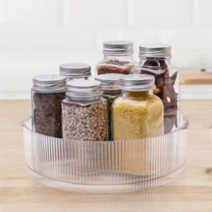 Clear glass jars with metal lids for spices and dry goods storage.