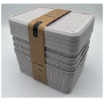 Stacked white plastic storage baskets with lids for home organization.