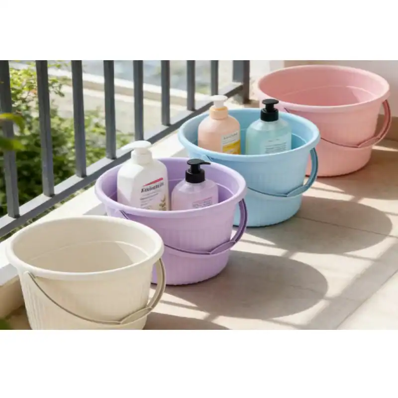 Set of pastel-colored plastic storage buckets with handles on balcony.